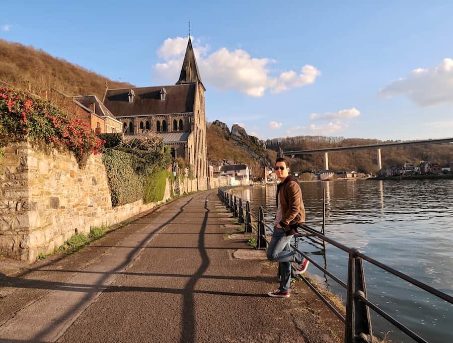 Jeff leans against a rail on the side of the River Meuse in Dinant