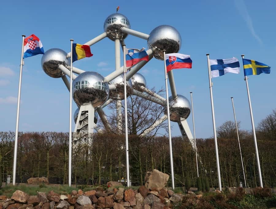 Image showing a giant molecule building known as the Atomium, behind some European flags