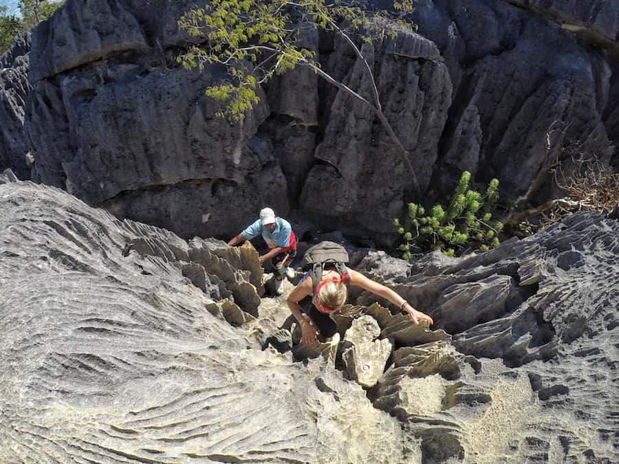 Image looking down on Zuzi as she climbs up the steep cliff face at Tsingy de Bamaraha. 