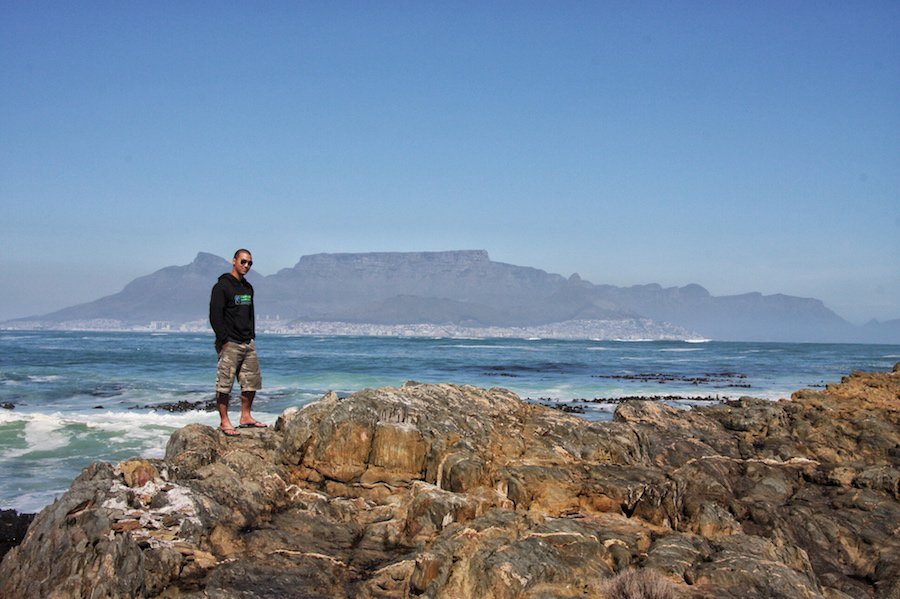 Jeff stands on Robben Island with a view of Cape Town just behind