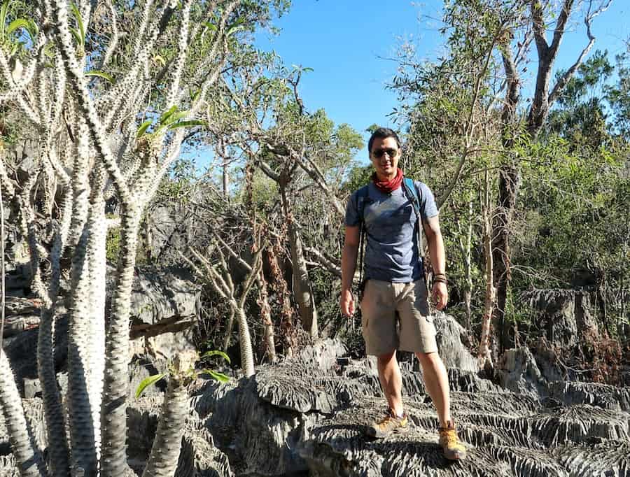 Jeff stands amongst thin spiky trees at the Petit Tsingy National Park in Madagascar 