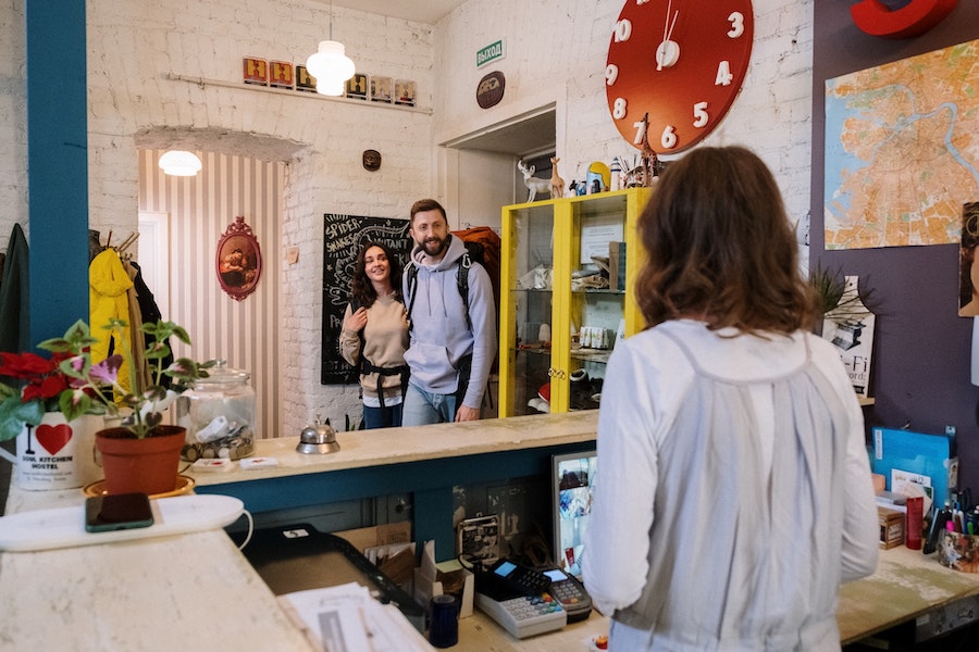 Image of two backpackers arriving at a hostel