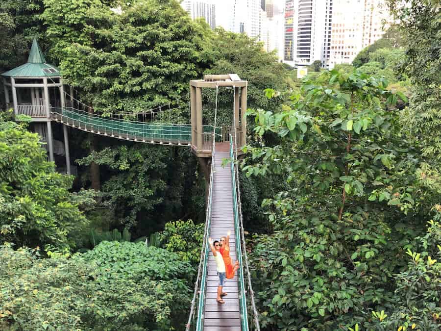 Jeff and Zuzi wave from a bridge above the tree at an eco park in Kuala Lumpur