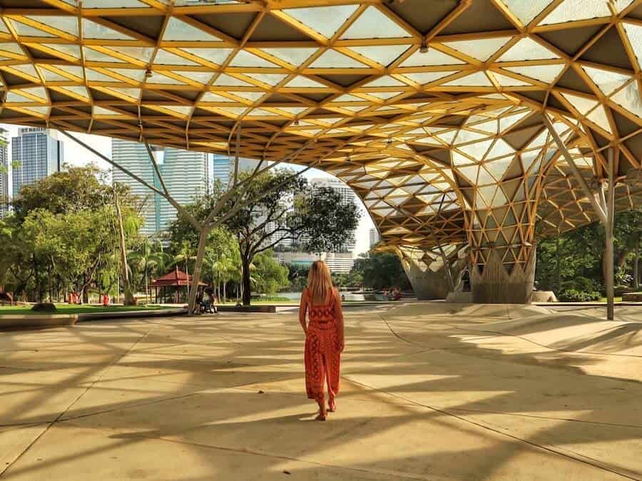 Zuzi walks under a glass roof at the Perdana Botanical Gardens 