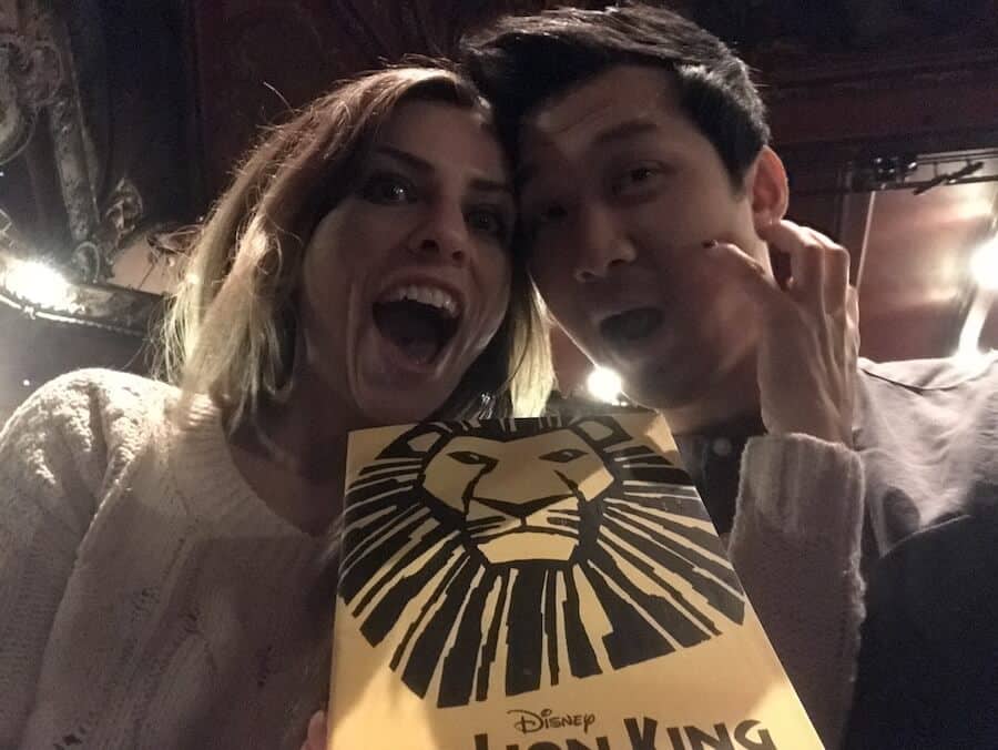 Jeff and Zuzi in a theatre with The Lion King booklet