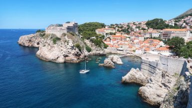 Cover image for The Best Things To Do In Dubrovnik post showing a fort and cliffs against the sea