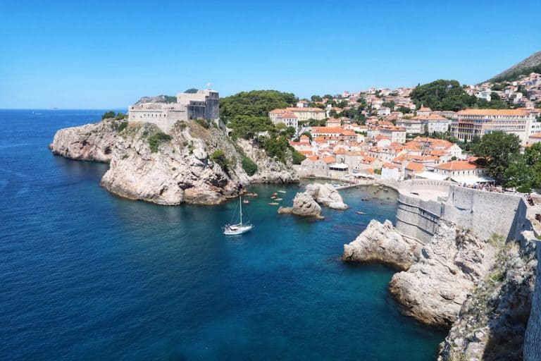 Cover image for The Best Things To Do In Dubrovnik post showing a fort and cliffs against the sea