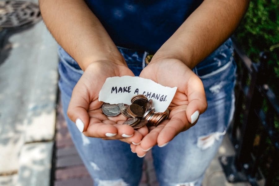 Image of a pair of hands holding out look change with a note saying make a change