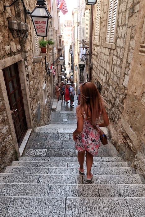 Zuzi walking down some stairs in the backstreets of Dubrovnik Old Town