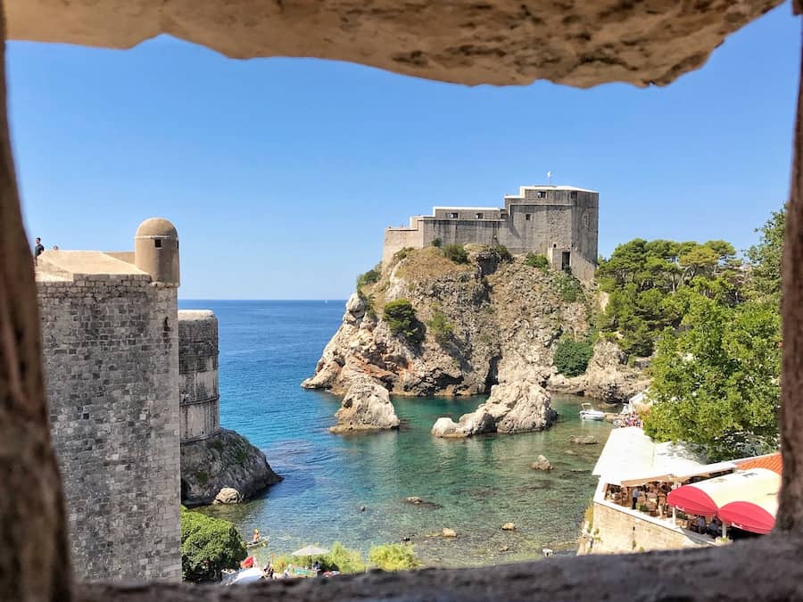 Image of Fort Lovrijenac through the window of a wall in Dubrovnik Old Town