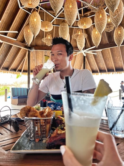 Image of Jeff drinking with another drink in front of the camera