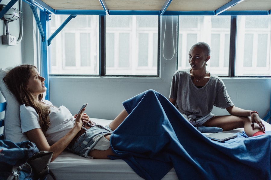 Images of two girls talking on a bunk bed