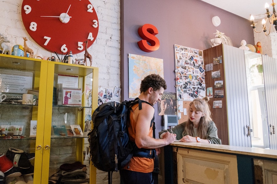 image of a backpacker at the reception of a hostel