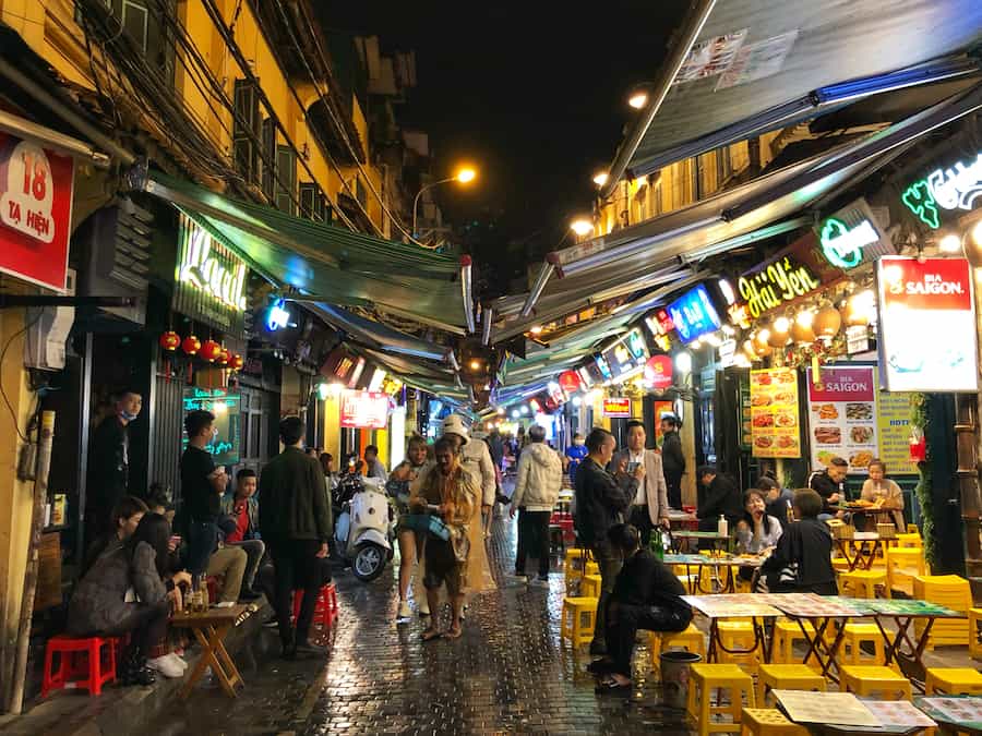 Image of a street in Vietnam where locals are having fun eating and drinking