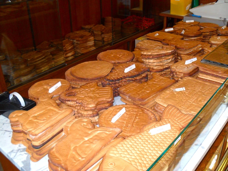 Image of Couques de Dinant - a local brown biscuit cookie on display in a shop 