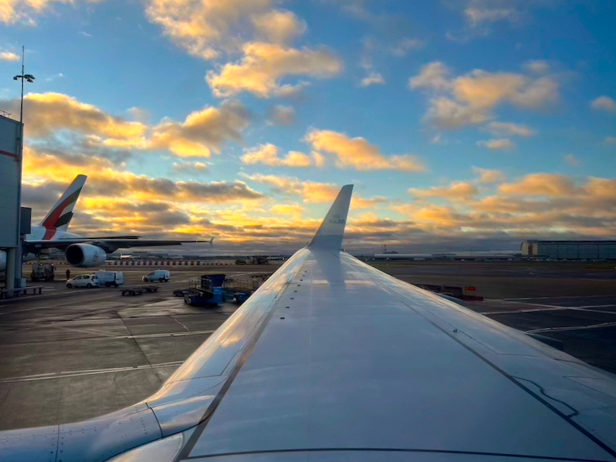 Image of an airplane wing at an airport during sunset - for the blog post Airport Transportation In Aruba