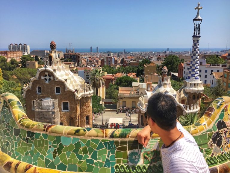 Cover image for Is Barcelona Worth Visiting blog where Jeff is sitting on a colourful bench at Park Guell