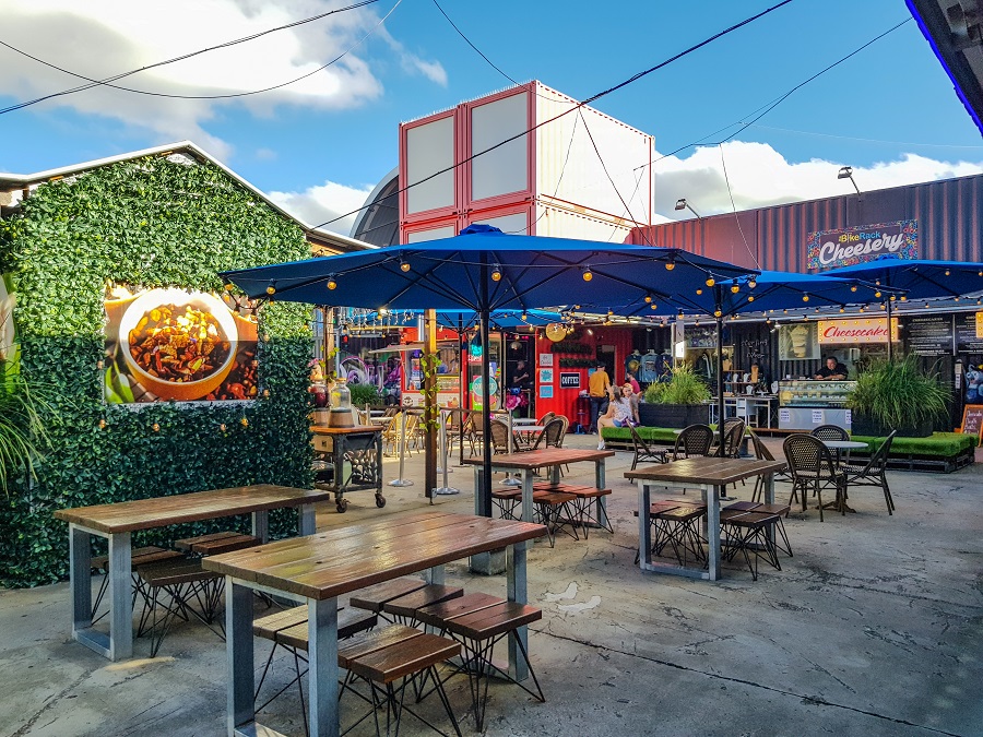 Brisbane Eat Street Markets, featuring a vibrant night scene with various food stalls