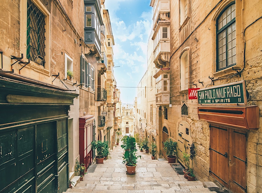 streets of Valletta showing sandy brick buildings along a street