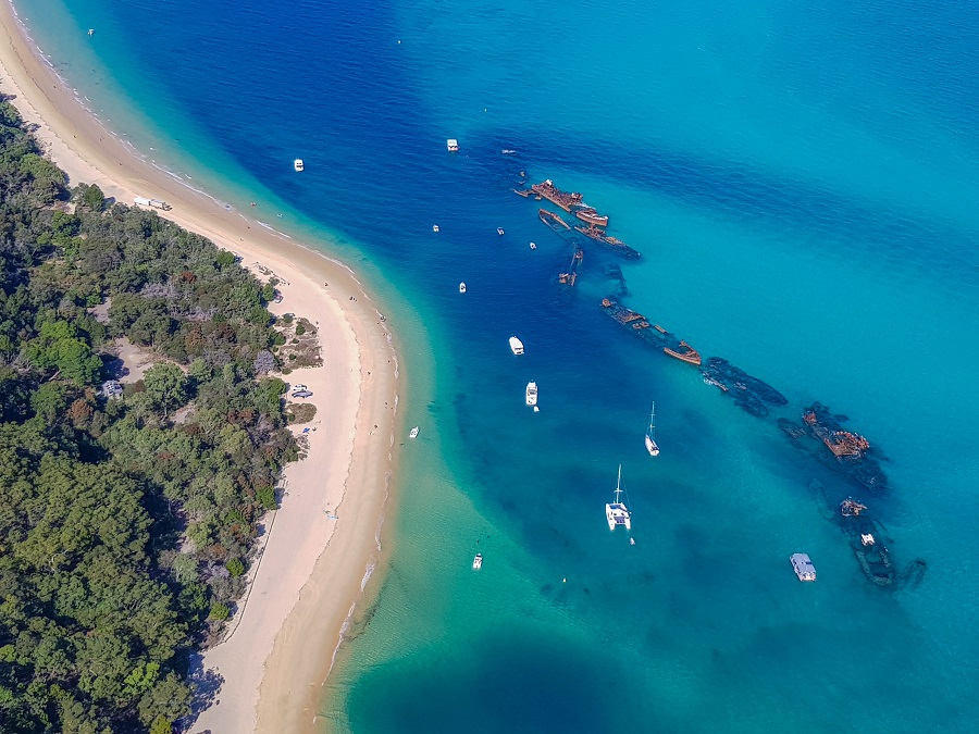 Aerial view of Moreton Island, showcasing its stunning coastline, sandy beaches, and surrounding turquoise waters from above.