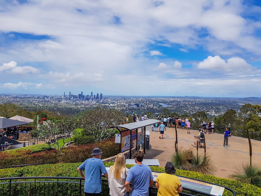 Scenic view from Mount Coot-Tha lookout, featuring lush landscapes, distant hills, and a clear sky