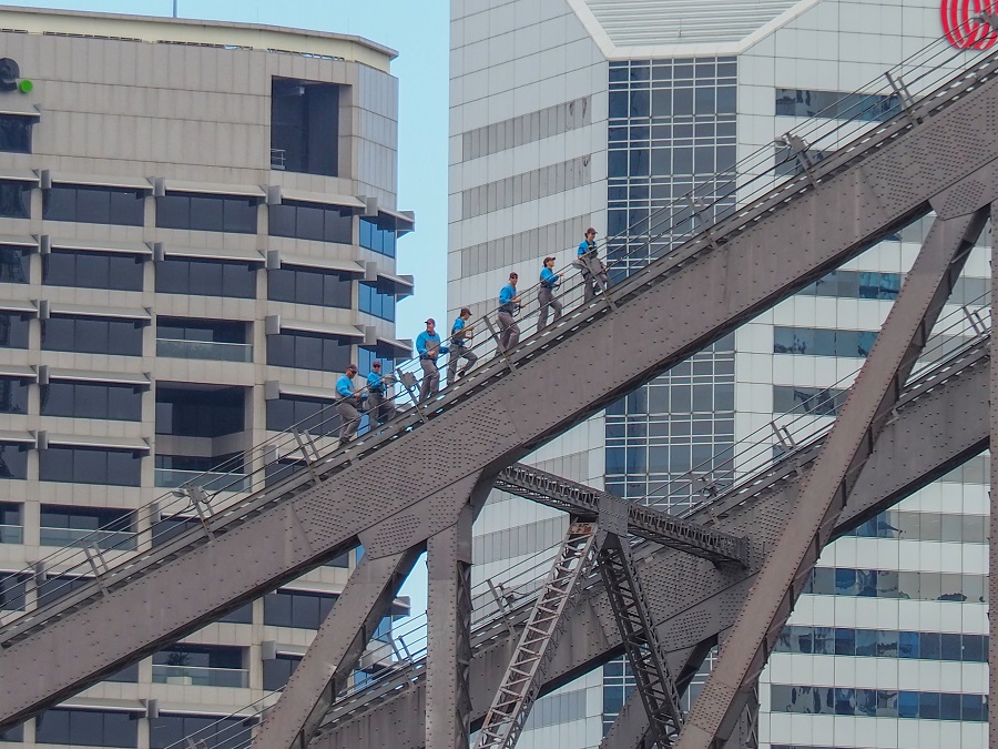 Story Bridge Adventure Climb, showcasing climbers ascending the iconic bridge structure with cityscape in the background.