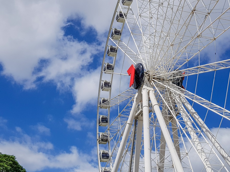 View of the Wheel of Brisbane, a tall observation wheel, against the city backdrop