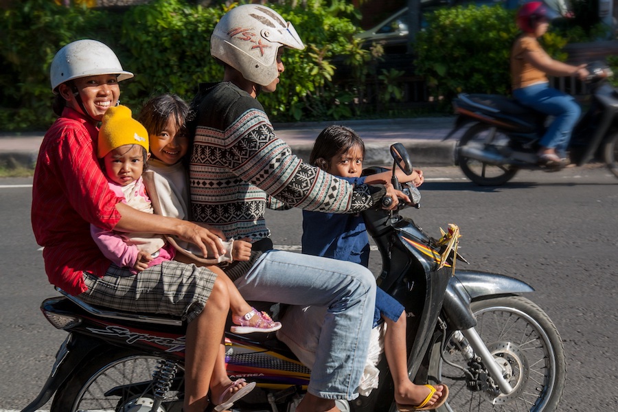 Family of four all on one motorbike in Bali