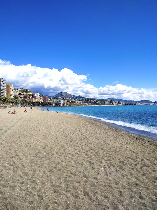 The sandy shore of Malagueta Beach in Malaga