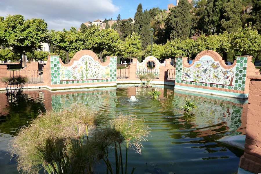 Fountain of water at Parque de Malaga with trees in the background