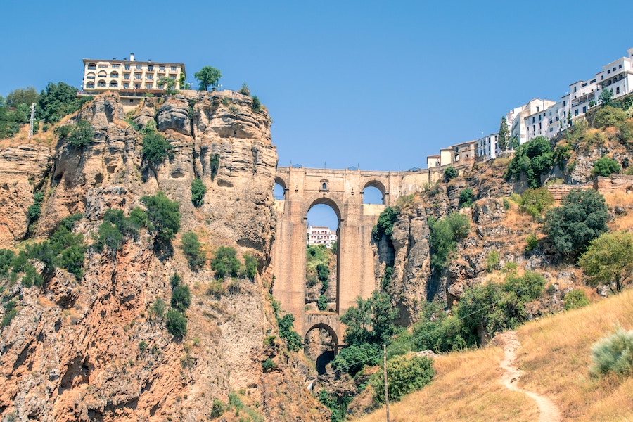 A tall bridge connects two sides of a mountain village in Ronda