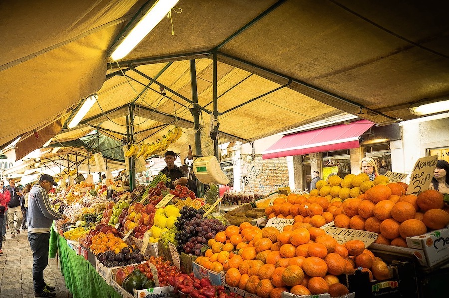 Colourful markets in Venice showing bright oranges and other fruits