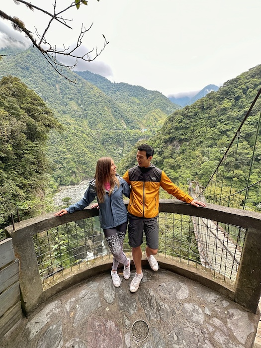 Couple standing on viewpoint near Pailón del Diablo in the Ecuadorian Andes