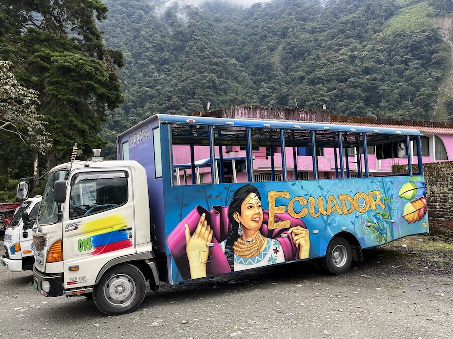 Painted open-air tourist bus in Ecuador with mural of Indigenous woman.
