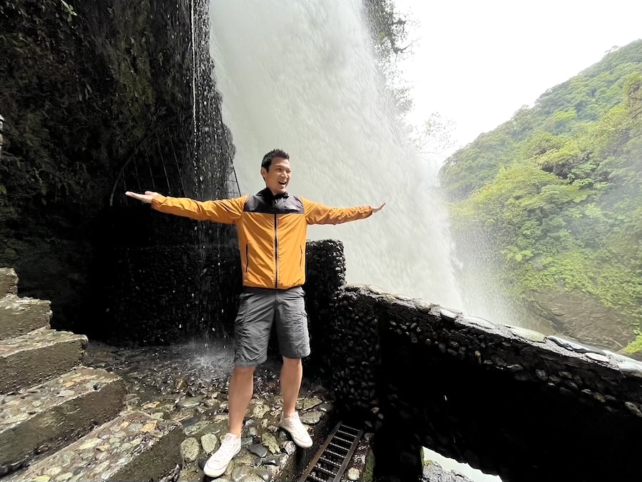 Drenched visitor at close-up waterfall platform at Pailón del Diablo