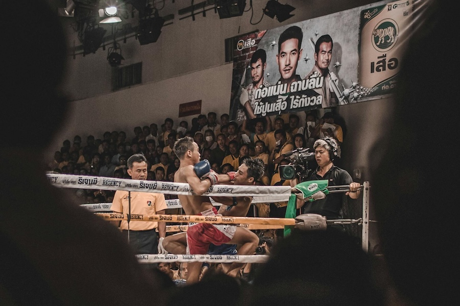 Muay Thai fight taking place inside a stadium in Bangkok
