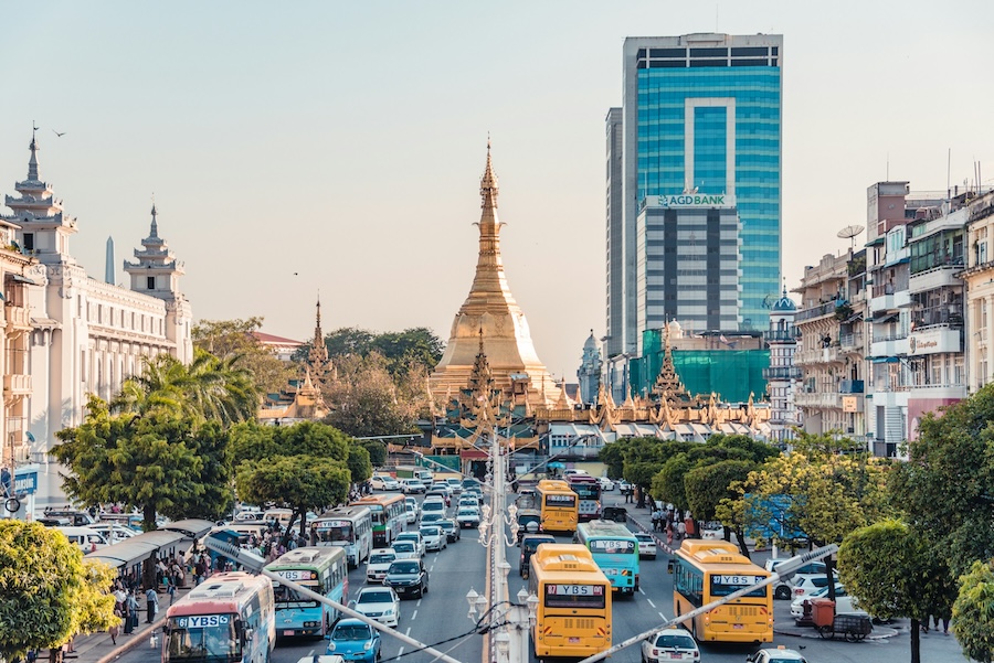 Traffic and city life in Yangon with Sule Pagoda rising in the centre